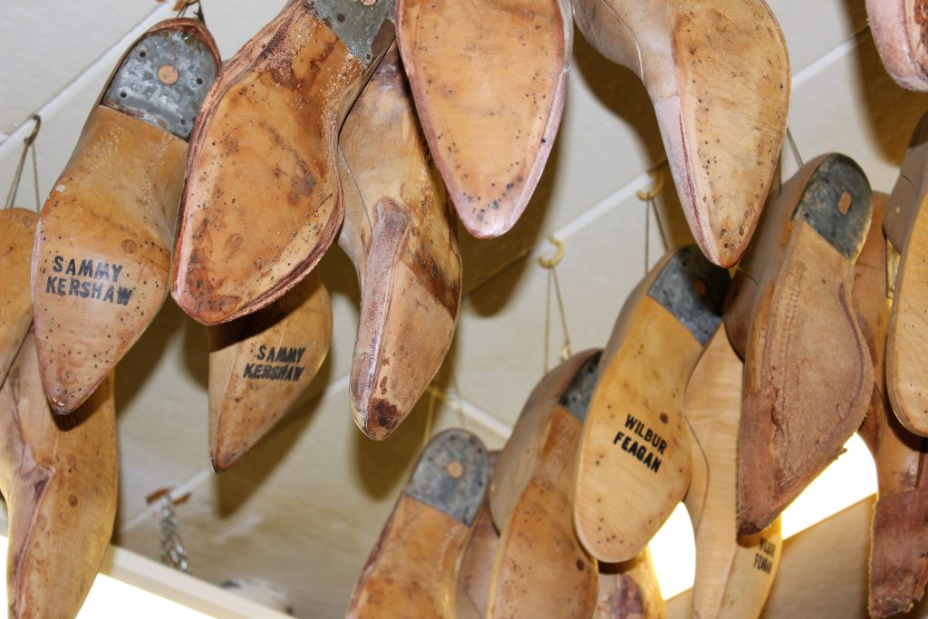 Wooden boot lasts hang from ceiling