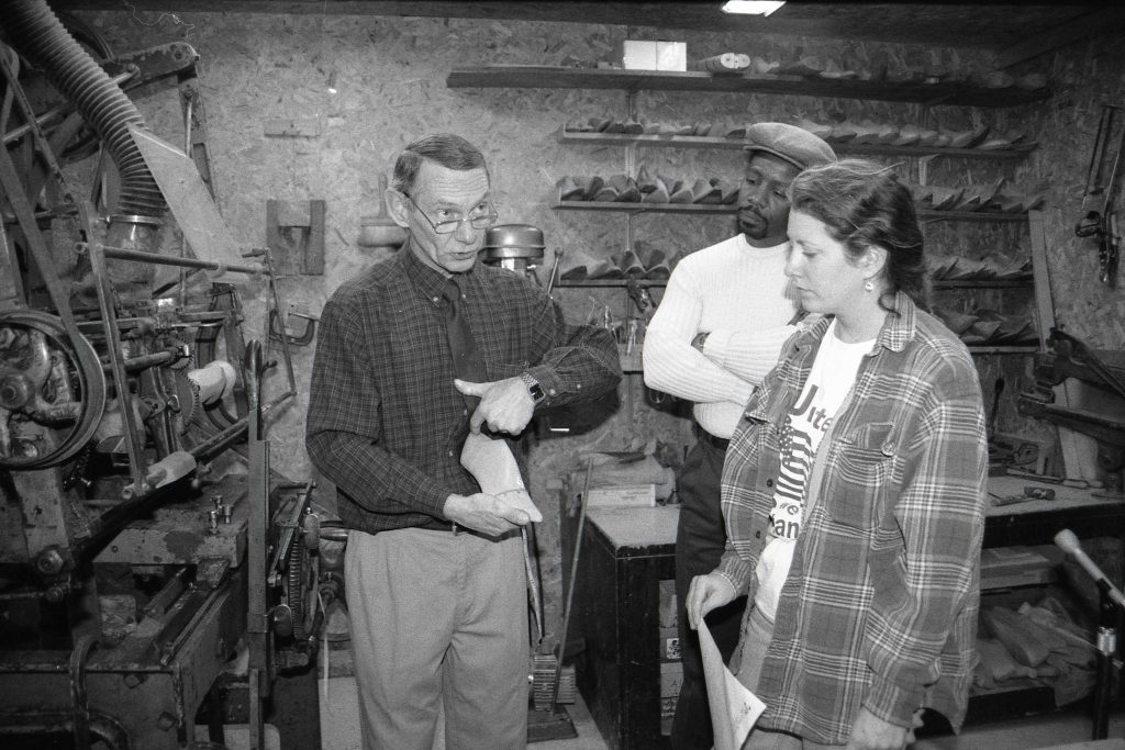 Joe and two apprentices pose in workshop