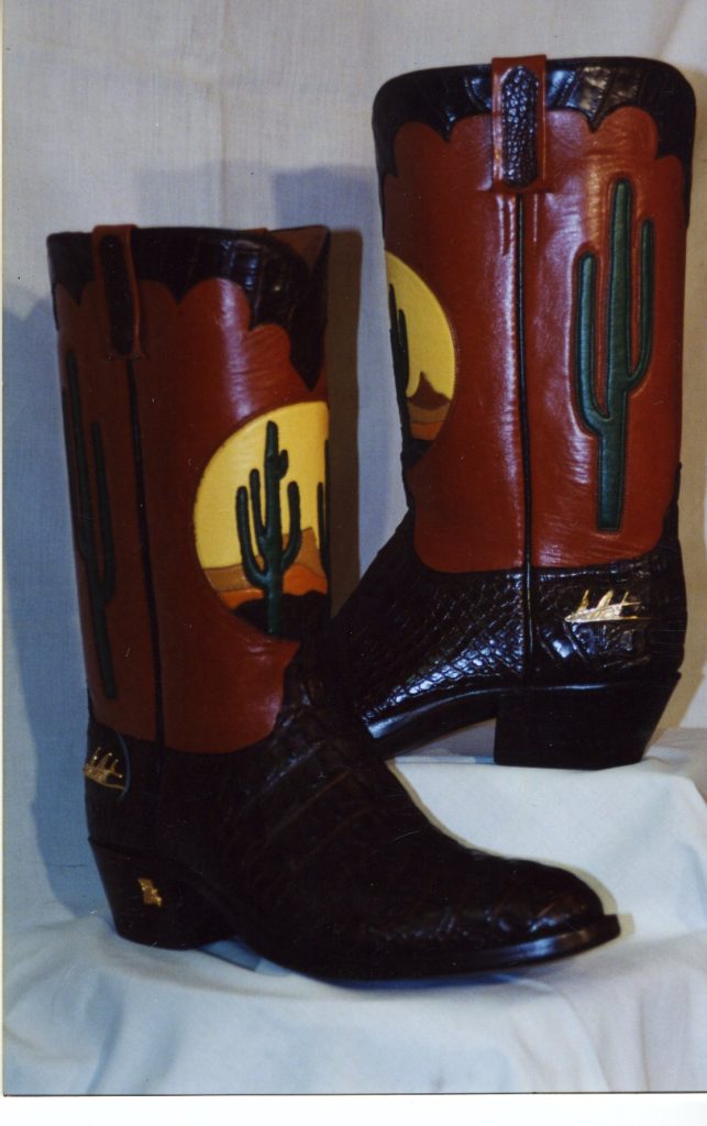 Red and black boots with cactus inlay