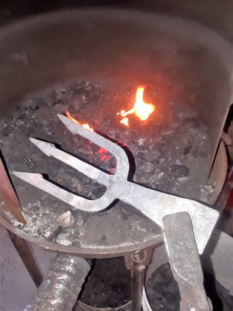 A three-prong gig in the hot coals