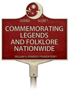 Red sign reads, "Legends & Lore, Commemorating Legends and Folklore Nationwide, William G. Pomeroy Foundation"