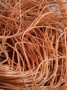 Close up photo of hay bale twine, the orange tinted twine is long and spiraly.