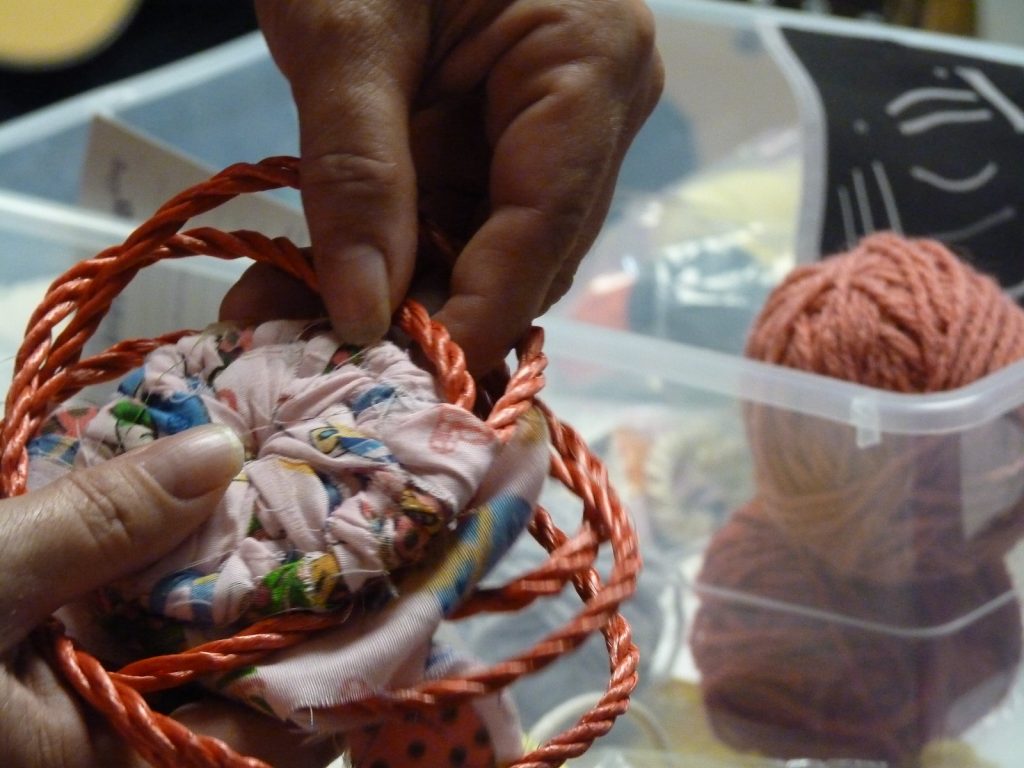coiled twine being made woven into a basket