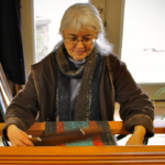 Woman weaving a loom