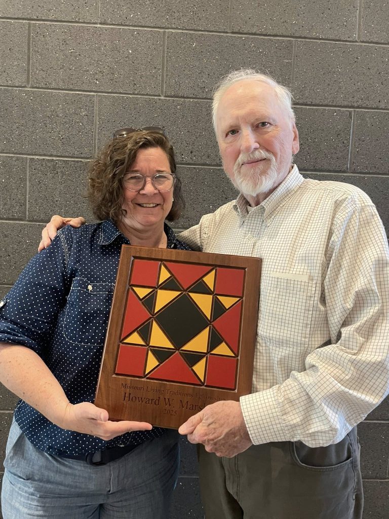 Folk Arts director present custom wood plaque to Howard W. Marshall.