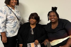 Three women pose for a portrait