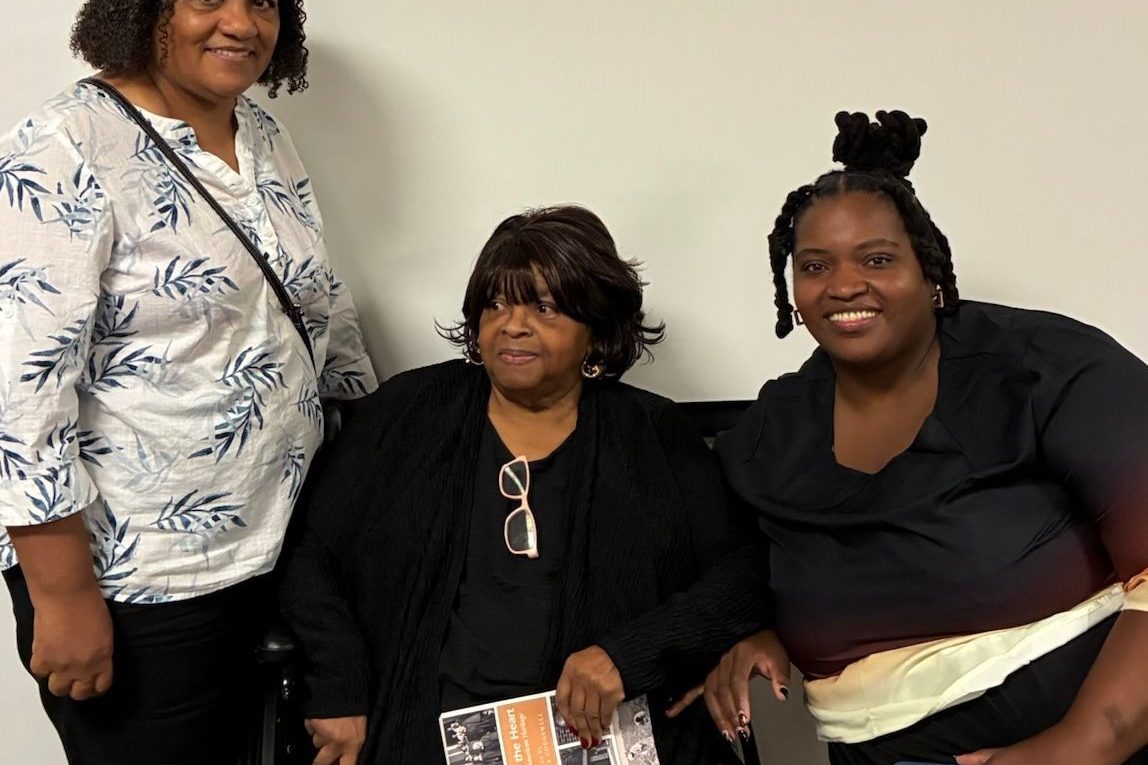 Three women pose for a portrait